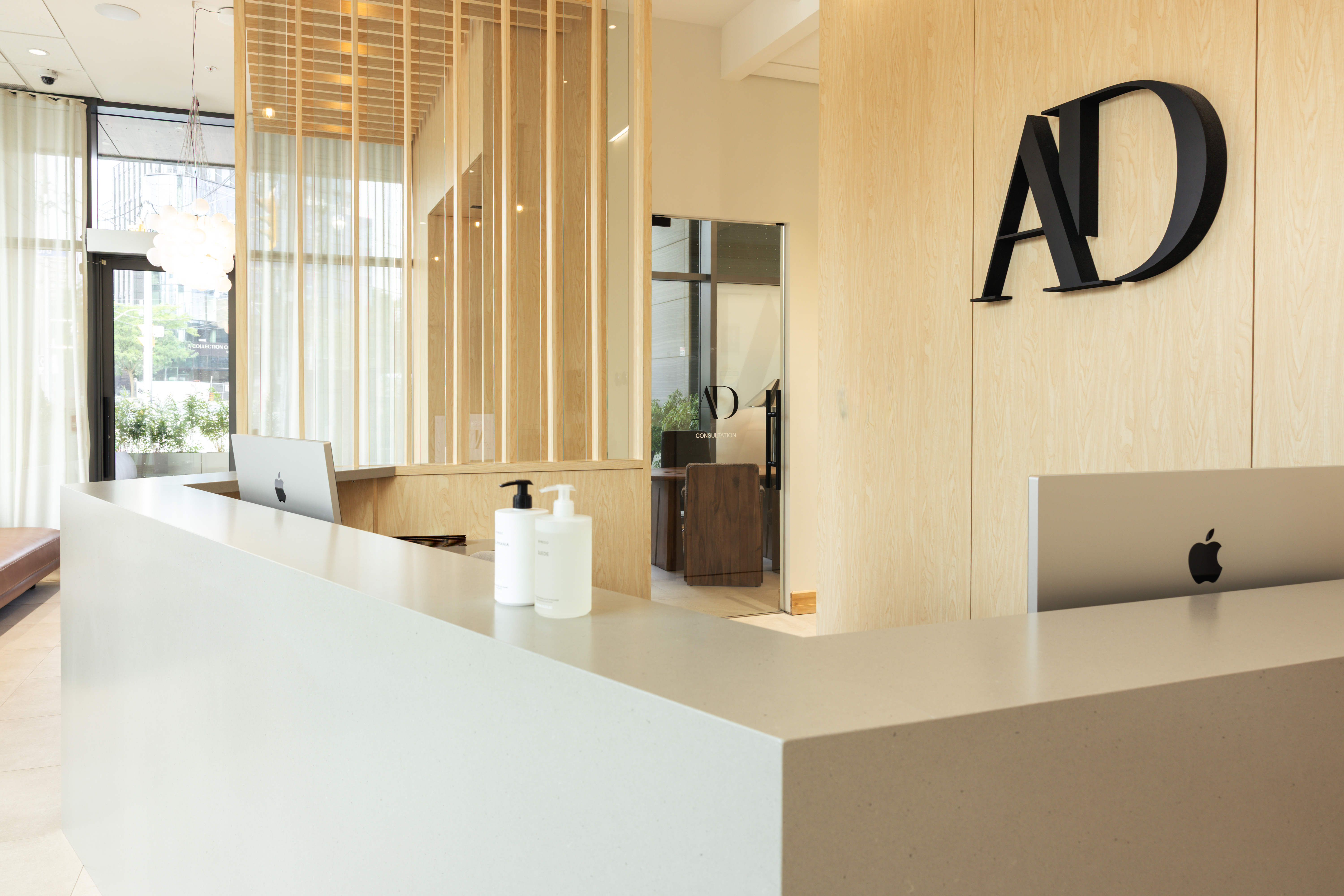 Warm wood finishes and welcoming reception desk at Ashraf Dentistry